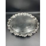 A silver tray with engraved design on ball and claw feet, hallmarked for Sheffield 1855 by Martin,