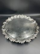 A silver tray with engraved design on ball and claw feet, hallmarked for Sheffield 1855 by Martin,