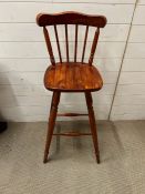 A pine high bar stool with spindle back