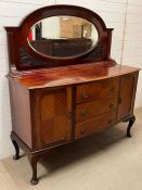 A mahogany sideboard with mirror back, drawers to centre and flanked by cupboards (H160cm W152cm