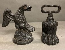 A pair of cast iron door stops lions paw and American eagle