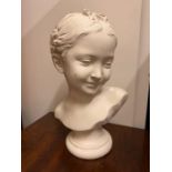 A plaster bust of a girl with a bow in her hair (H35cm)