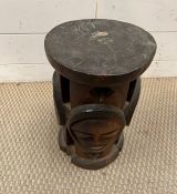 A tribal stool with carved figure to sides
