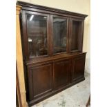 An oak glazed bookcase with three panelled cupboards under, all with adjustable shelves (H214cm