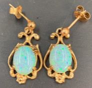A Pair of Opal and gold earrings
