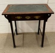 An oak hall table with scrolled ends and brass handles, leather top (H74cm W76cm D46cm)