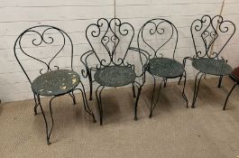 Four reclaimed garden metal chairs with scrolling backs and cut out seats