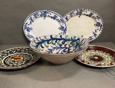 A mixture of five decorative plates and bowls