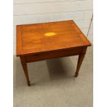 An inlaid table with shell motif and drawer to side