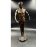 A bronze statue of a naked male