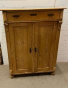 A pine tall cabinet with drawers and cupboard (H133cm W100cm D47cm)