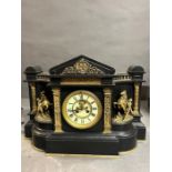 A black slate classical mantel clock with gilt rearing horses to sides and Roman embolised column