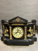 A black slate classical mantel clock with gilt rearing horses to sides and Roman embolised column