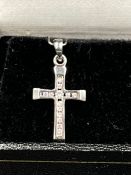 A 9ct white gold and diamond cross