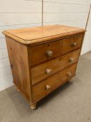 A two over two antique pine chest of drawers