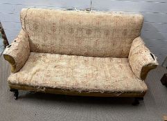 An Edwardian sofa on brass castors, upholstering as found