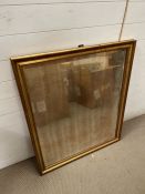 A gilt frame and foxed mirror (86cm x 104cm)