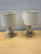 A pair of white bedside lamps