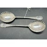 Pair of boxed silver fruit serving spoons with raised floriate decorative bowls and scroll and
