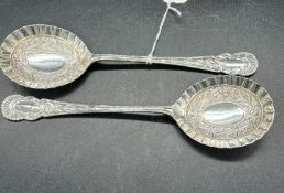 Pair of boxed silver fruit serving spoons with raised floriate decorative bowls and scroll and