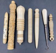 A selection of antique ivory items to include needle holders etc.