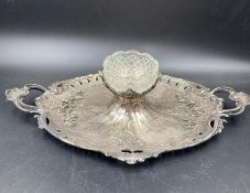 A silver plated ornate caviar server with central glass bowl