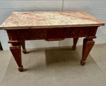 A marble top hall table on carved base with carved urns and floral decoration on tapering ribbed