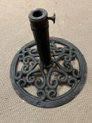 A cast metal umbrella stand