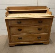 A pine chest of drawers with gallery top and brass handles (114cm x 49cm)