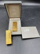 Two Dunhill lighters, rectangular shaped, one with a booklet and box