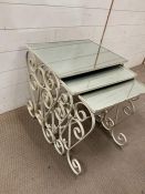A nest of three wrought iron and mirrored top tables (Largest H57cm W52cm D39cm)
