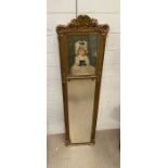 A gilt framed hall mirror with seated young girl
