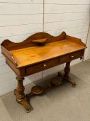 A pine wash stand with drawers to centre and jug stand to base (H89cm W110cm D48cm)