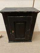 A painted black pine wall cupboard