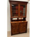 A mirrored back dresser with glazed bookcase top and a cupboard below (H224cm W124cm D50cm)