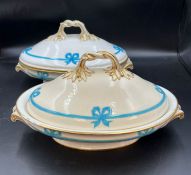 A pair of lidded tureens with blue bow details