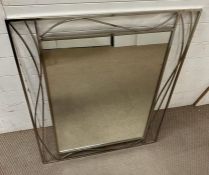 A contemporary mirror with scrolling frame