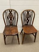 A pair of wheel back chairs