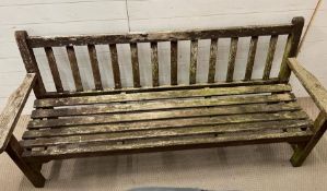 A wooden weathered teak slat bench (H85cm W180cm D62cm)