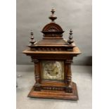 A German carved oak eight day mantel bracket clock possibly by Junghans