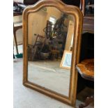An arched mirror with moulded wooden frame and beading detail (143cm x 102cm)