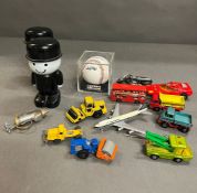 A selection of various toys, baseball, vehicles and moneyboxes