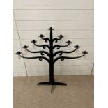A wrought iron candle holder with glass drops (92cm x 94cm)