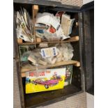 A selection of tea cards and cigarette cards in a wooden trunk