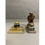 A wooden eagle inkwell and a brass inkwell