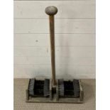 A wooden boot brush stand