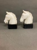A Pair of Horse head bookends on marble plinths