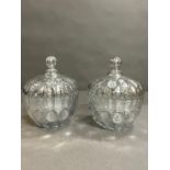A pair of decorated glass lidded pots