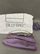 A purple satin clutch bag by Billy