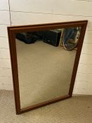 A wall mirror with faux wood frame (70cm x 39cm)